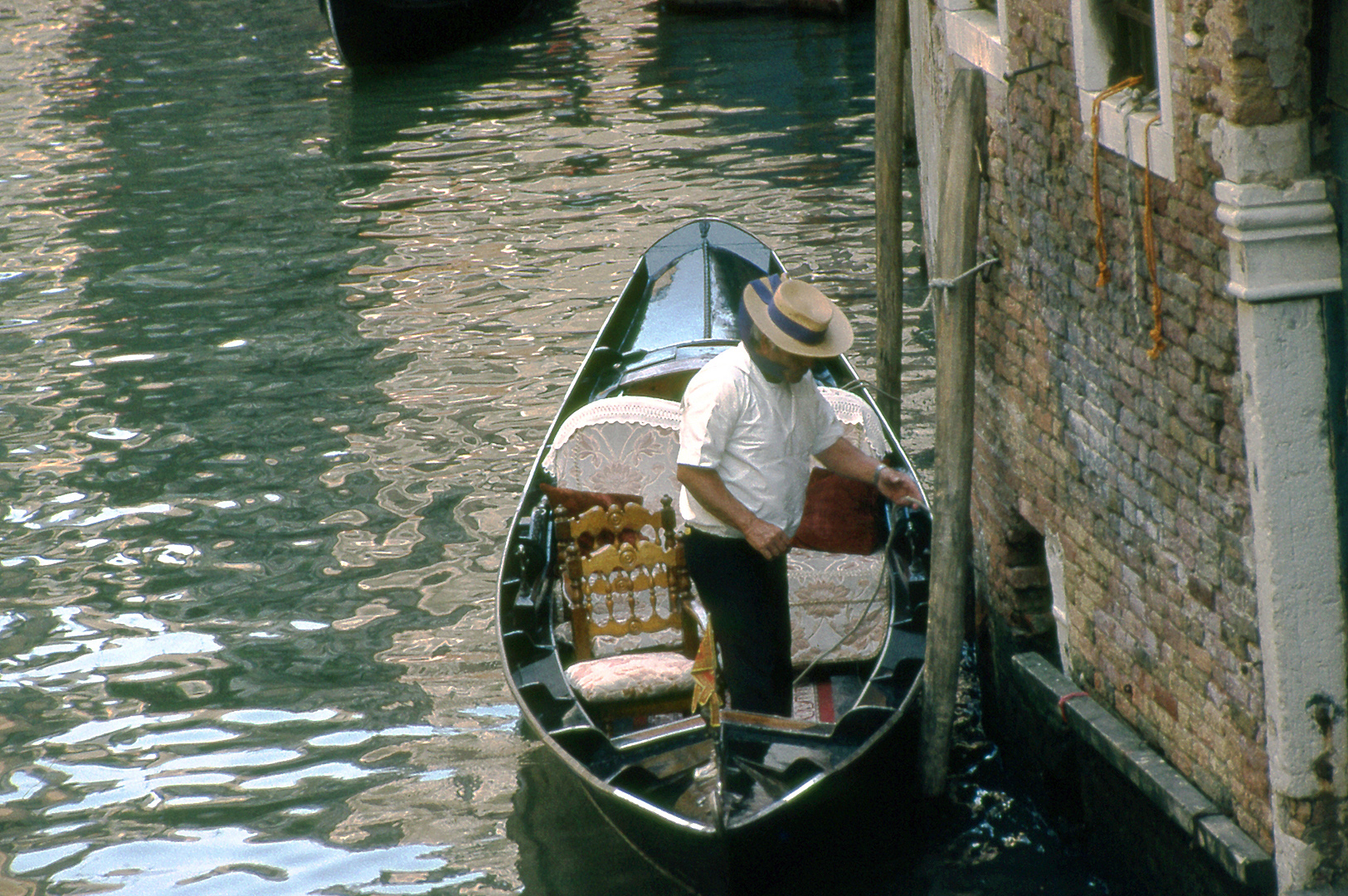 Gondelier in een gondel (Veneti, Itali); Gondolier in a gondola (Venice, Italy)